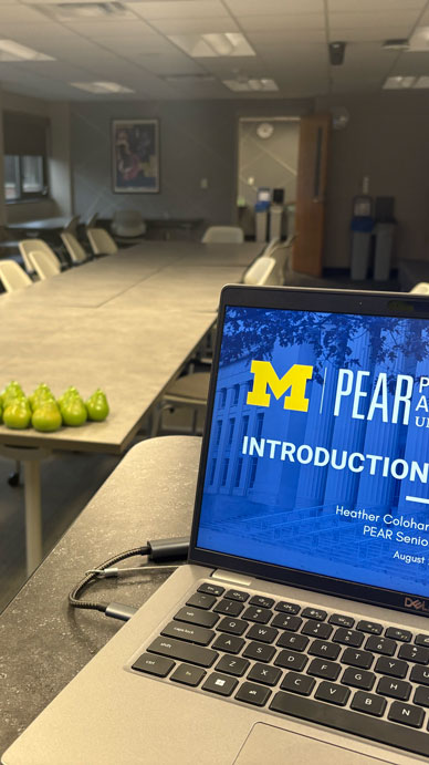 Laptop with a PEAR presentation in a training room.