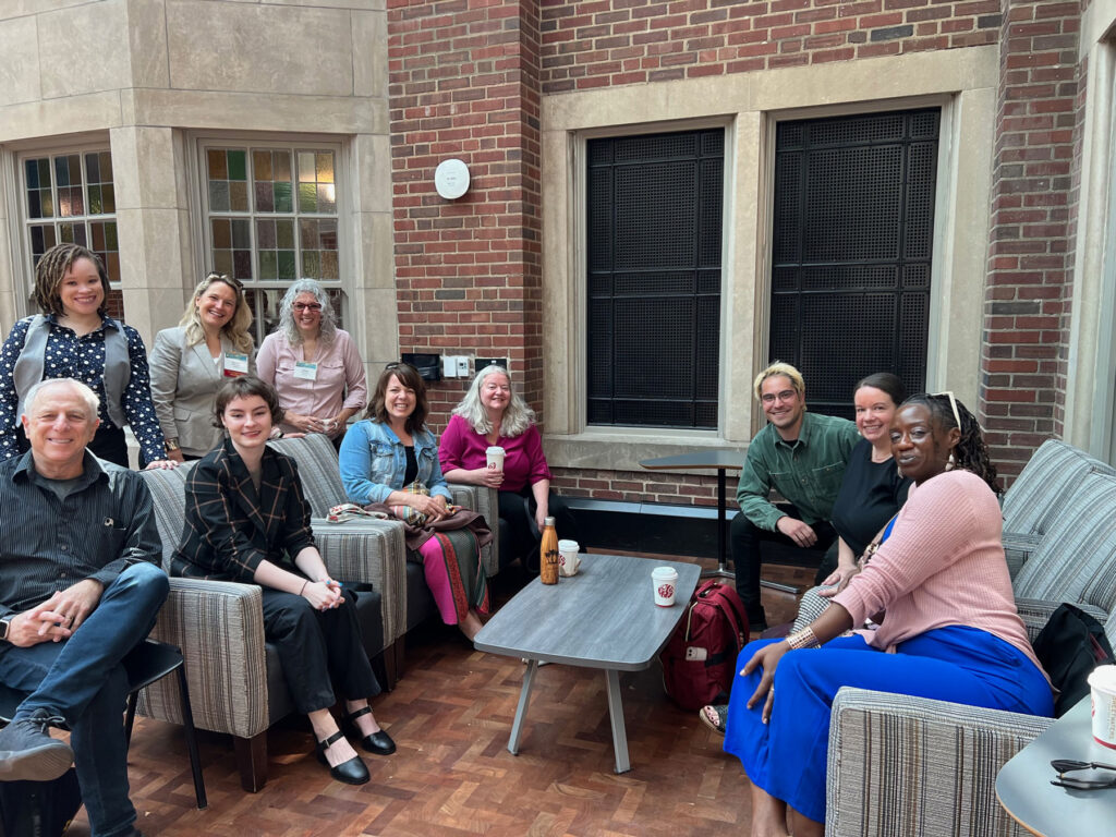 Speakers from a conference seated together from the SHGBV Conference talking and drinking coffee.