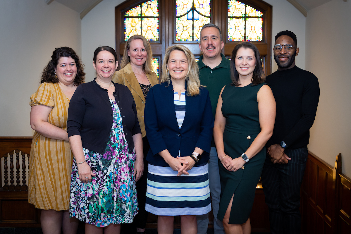 The PEAR Team standing in front of a stained glass window in the Michigan League.