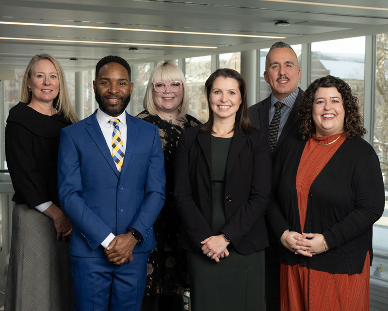 A group of six people wearing business clothes.