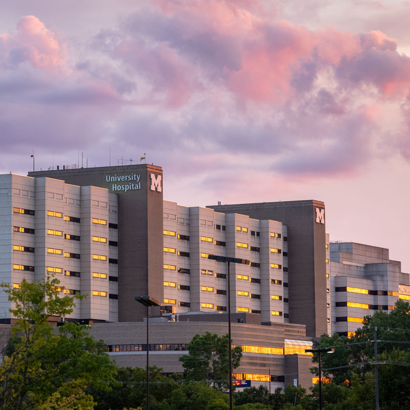 The outside of the University Hospital in Ann Arbor during a sunset.